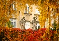 old statues and colorful autumn foliage in Vienna