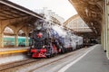 Old steam locomotive at an antique vintage train station. Royalty Free Stock Photo