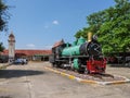Old locomotive in front of a railway station in Thailand