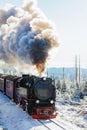 An old steam locomotive in snow-covered landscape Royalty Free Stock Photo