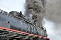 Closeup view old steam locomotive train boiler with black grey smoke. Red line Royalty Free Stock Photo