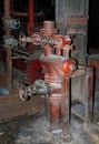 An old steam shut-off valve in a disused industrial hall.