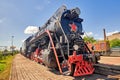 Old steam train on the rails. Close-up wide angle Royalty Free Stock Photo