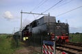 Old steam train from the SSN organization in Rotterdam running at the railroad track in Nieuwerkerk aan den IJssel in the Netherla