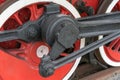 Old steam train wheels approaching, close-up. Black and red wheels. Rails and sleepers Royalty Free Stock Photo