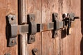 An old steel black and rusty latch lock on the wooden door. On the end is a padlock. Close-up shot Royalty Free Stock Photo