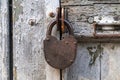 Old steel door lock on an old battered door Royalty Free Stock Photo