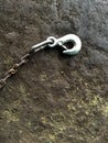 Old steel hook on dirty old cement floor