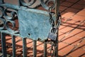 Old steel padlock hanging on chain at rusty metal fence Royalty Free Stock Photo