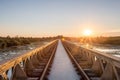 Old steel railway bridge on the river with beautiful sunset Royalty Free Stock Photo