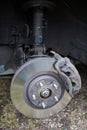 Old steel ventilated brake disk with fixed calliper and brake pads are ready for removing, front wheel