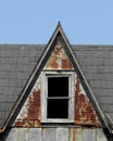 Old steep roof dormer with window.