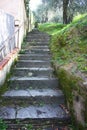 Old steep stairway uphill in rock, long endless. path that runs along the gardens