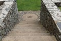 Old steps lead down from the house and patio to the lawn in the grounds of an English country house in Devon Royalty Free Stock Photo