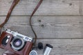 Old still camera in brown leather case on wooden desk Royalty Free Stock Photo