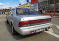 Old classic Japanese sedan car Nissan Maxima parked