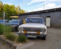 Classic old Soviet white sedan car Lada 124 front part view with logo on grille