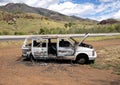 Old stolen car which was stripped and left to rust alongside the highway on the island of Maui in the state of Hawaii.