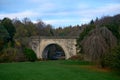 An old stone arch bridge in Dalkeith, Scotland, framed by autumn trees Royalty Free Stock Photo