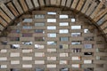 old stone arch/window with brickwork inside outdoor Royalty Free Stock Photo
