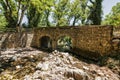 Old, stone, arched bridge across the river near Agia Theodora of Vasta church in Peloponnese, Greece Royalty Free Stock Photo