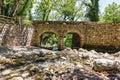 Old, stone, arched bridge across the river near Agia Theodora of Vasta church in Peloponnese, Greece Royalty Free Stock Photo