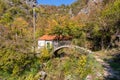 Old stone arched bridge covered with moss over Seljani stream in idyllic village Poseljani in Lake Skadar National Park Royalty Free Stock Photo