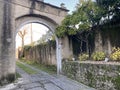 Old stone archway in the garden of the medieval village Royalty Free Stock Photo