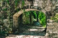 An old stone archway in the middle of a forest Royalty Free Stock Photo