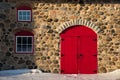 Old Stone Barn with Bright Red Door Royalty Free Stock Photo