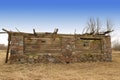 Old stone barn almost fallen with wooden roof top cover Royalty Free Stock Photo