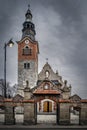 Old stone and brick church with clock tower in Bialka Tatrzanska, Poland Royalty Free Stock Photo