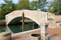 Old stone bridge and stone fountain on the island Torcello. Lagoon of Venice.