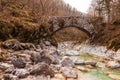 Old stone bridge across small stream in the woods Royalty Free Stock Photo