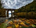 Old stone bridge at Baikal lake with autumn leaves Royalty Free Stock Photo