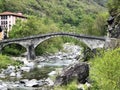 An old stone bridge over the Maggia River in the village of Bignasco The Maggia Valley or Valle Maggia or Maggiatal