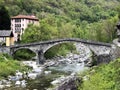 An old stone bridge over the Maggia River in the village of Bignasco The Maggia Valley or Valle Maggia or Maggiatal