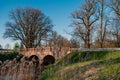 Old stone bridge over the river in the park in spring