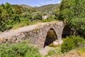 An old stone bridge over a stream Royalty Free Stock Photo