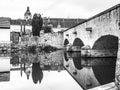 Old stone bridge reflected in calm water, Putim, Southern Bohemia, Czech Republic