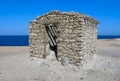 old stone building on Big Brother Island, tourist yachts in the background, Red Sea, Egypt