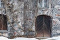 Old stone building detail, door and window, Virginia creeper climbing on weathered rugged wall Royalty Free Stock Photo