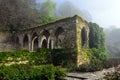 An old stone building and a gazebo in the forest. Royalty Free Stock Photo