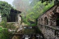 An old stone building and a gazebo in the forest.