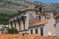 Old stone building with a tiled roof and boarded up windows in Dubrovnik Royalty Free Stock Photo