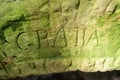 Old stone carved with word, 'GRATIA' meaning 'thanks' on St Mary's Well, Jesmond Dene, Newcastle UK Royalty Free Stock Photo