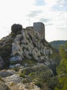 Old stone castle perched on a rugged hill overlooking a valley in the Alpilles in Provence in France