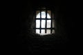 Old stone castle window with iron bars Royalty Free Stock Photo