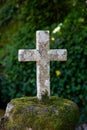 Old stone Catholic cross in the forest