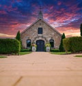 Old stone church built in 1857 with wine barrels decorated with flowers Royalty Free Stock Photo